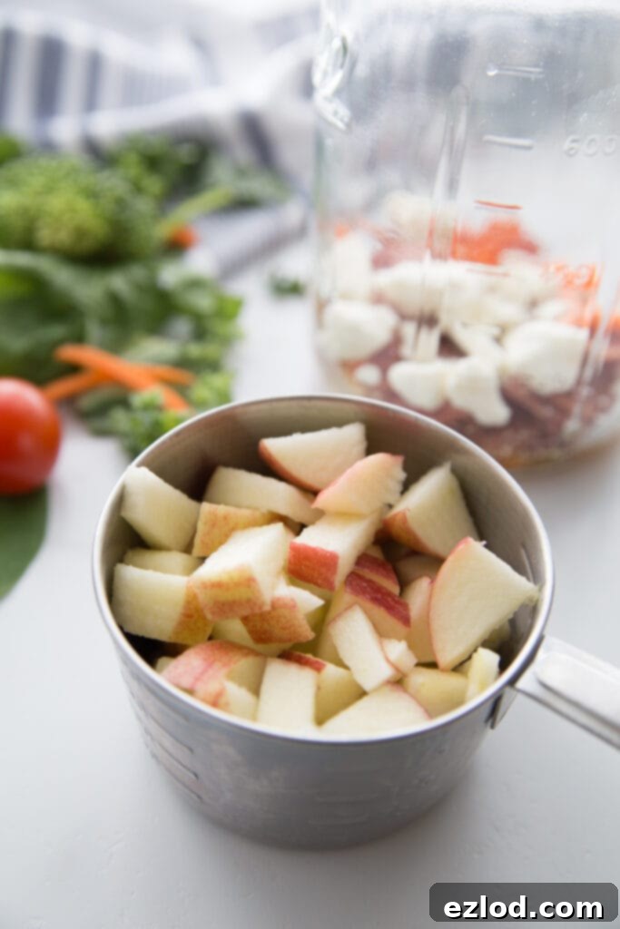 Several Fall Harvest Mason Jar Salads lined up, showcasing the beautiful layered ingredients and the practicality of meal prepping multiple healthy lunches at once.