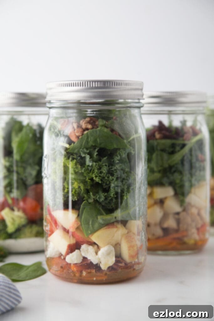 A beautifully arranged Fall Harvest Mason Jar Salad, featuring the vibrant colors and textures of its ingredients, symbolizing healthy and delicious meal prep.