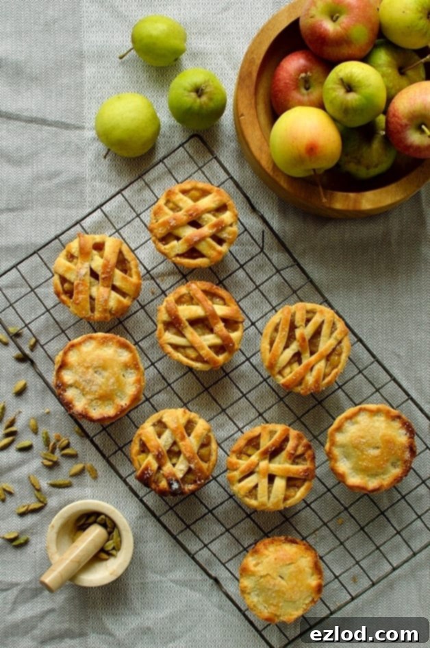 Mini cardamom and cinnamon spiced apple hand pies baked in a muffin tin, perfect for thanksgiving or Christmas
