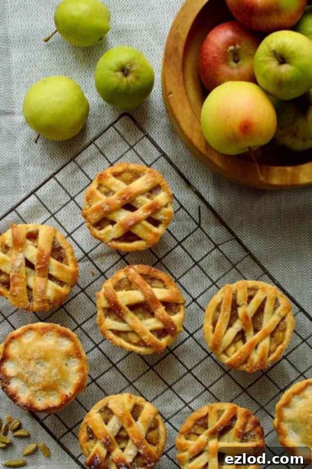 Mini apple hand pies baked in a muffin tin spiced with cardamom and cinnamon, ready for serving