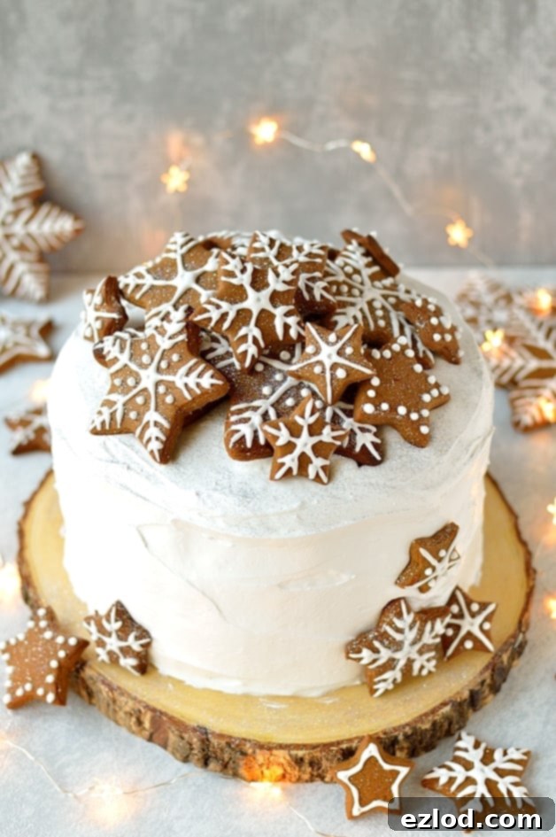 Rich Christmas fruitcake, beautifully covered with marzipan and royal icing, ready for gingerbread decorations.