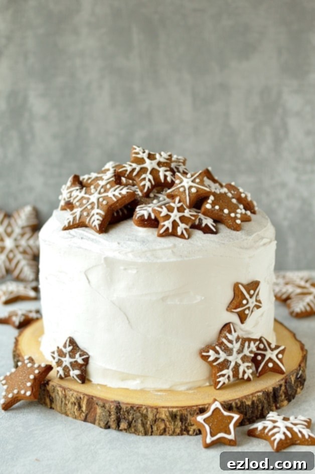 A festive table setting featuring the rich Christmas fruitcake topped with marzipan, royal icing, and gingerbread decorations.