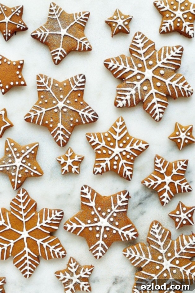 Close-up of a gingerbread star and snowflake cookies, beautifully decorated with royal icing, ready for holiday celebrations.