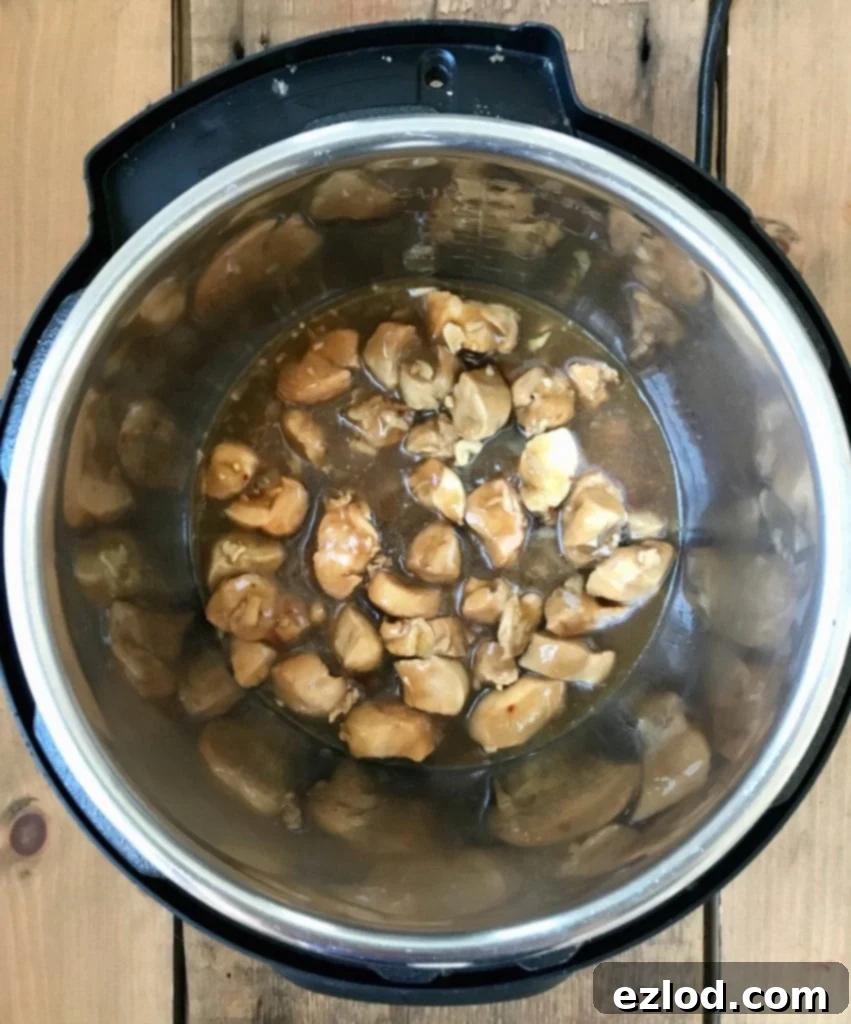 Overhead shot of diced chicken tenderloins, perfectly prepped for Instant Pot Chicken and Broccoli, ready to be cooked.