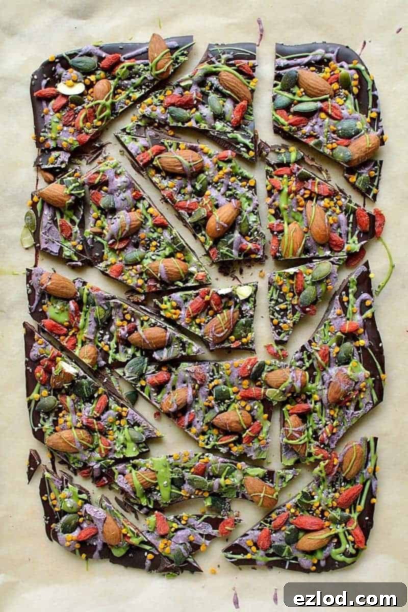 Superfood chocolate bark - dark chocolate topped with almonds, goji berries, seeds, bee pollen and white chocolate flavoured with matcha and freeze dried blueberry powder