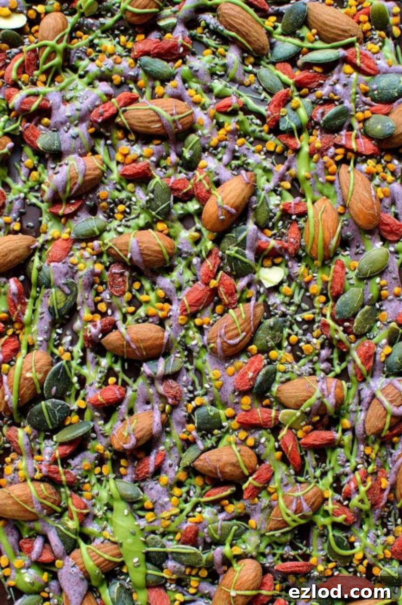Superfood chocolate bark - dark chocolate topped with almonds, goji berries, seeds, bee pollen and white chocolate flavoured with matcha and freeze dried blueberry powder
