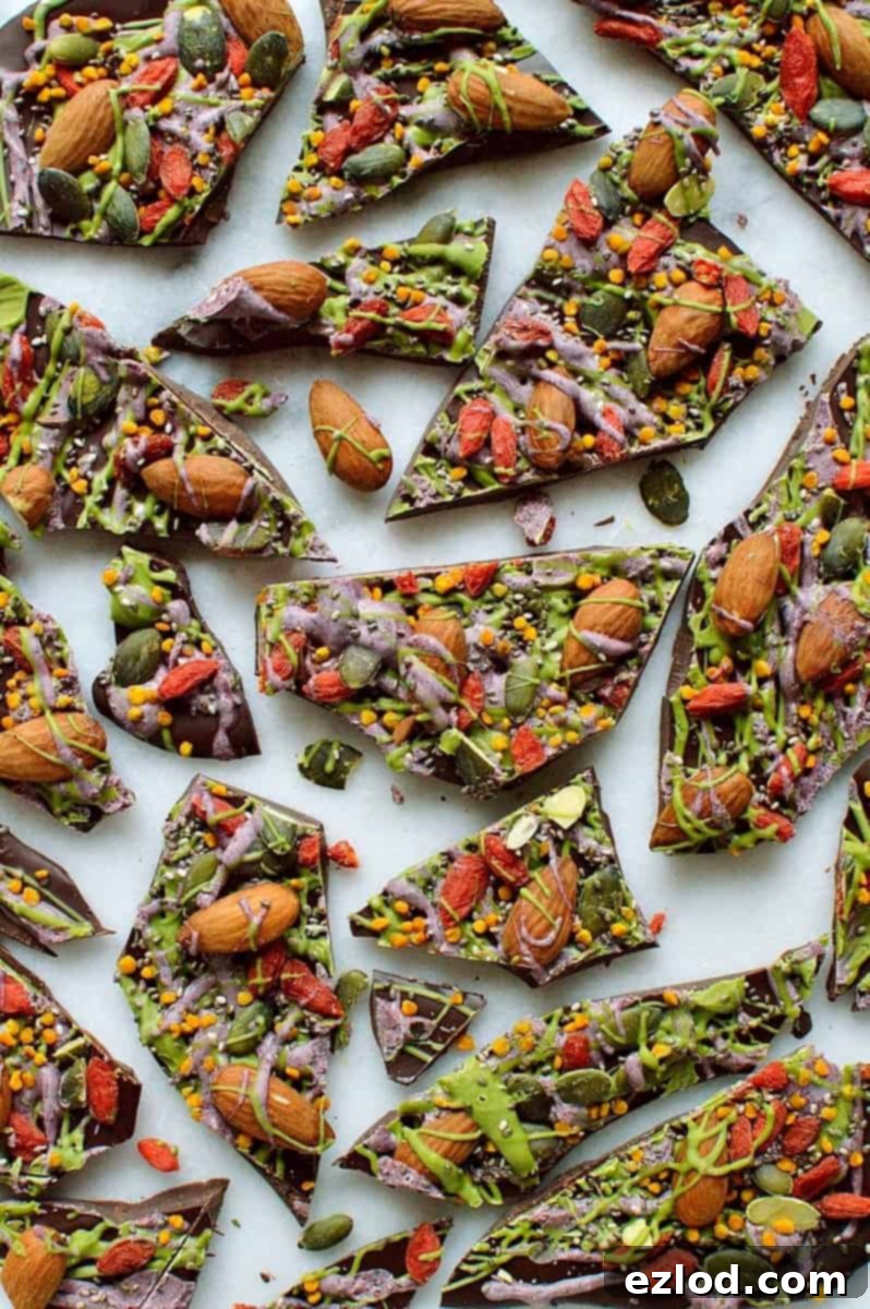 Superfood chocolate bark - dark chocolate topped with almonds, goji berries, seeds, bee pollen and white chocolate flavoured with matcha and freeze dried blueberry powder