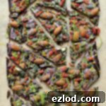 Superfood chocolate bark - dark chocolate topped with almonds, goji berries, seeds, bee pollen and white chocolate flavoured with matcha and freeze dried blueberry powder