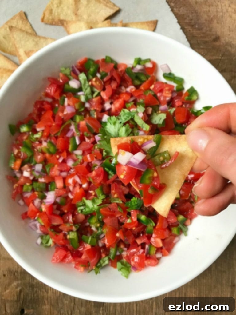 Homemade Pico de Gallo in a Bowl with a Spoon