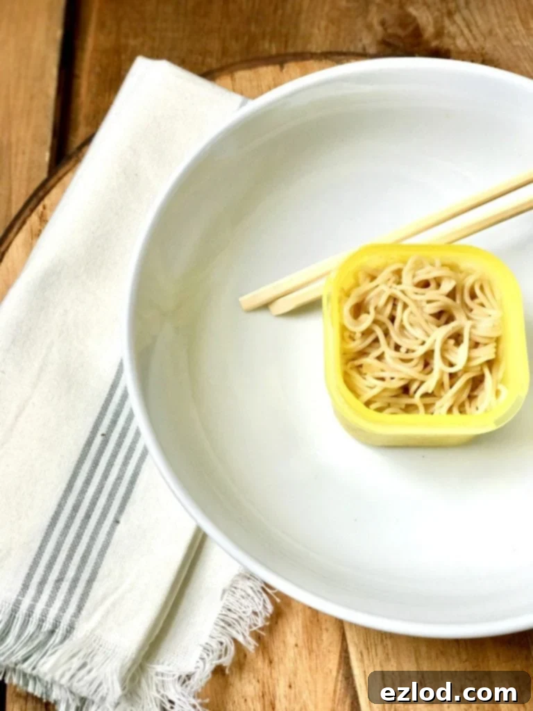 Close-up of Instant Pot Ramen Noodles broth, showing the rich texture and delicious ingredients.