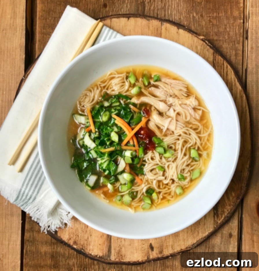 A bowl of finished Instant Pot Ramen Noodles garnished with fresh toppings.