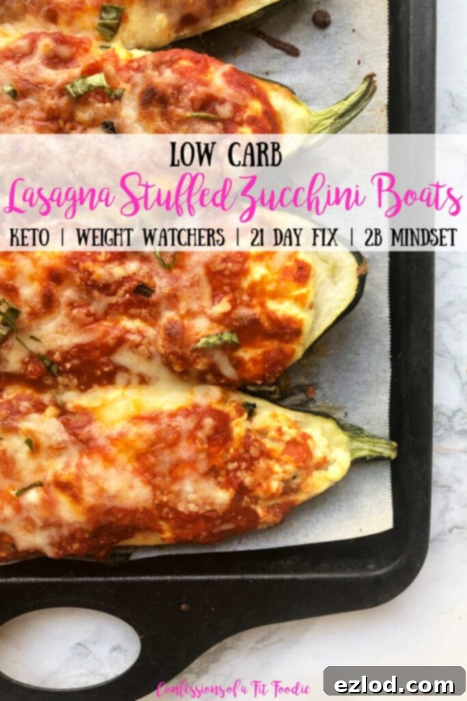 A beautifully presented baking sheet of golden-brown, bubbly, and crispy Low Carb Lasagna Stuffed Zucchini Boats on an elegant marble backdrop. The image includes a prominent text overlay: 'Low carb Lasagna Stuffed Zucchini Boats - Keto | Weight Watchers | 21 Day Fix | 2B Mindset - Confessions of a Fit Foodie', clearly highlighting its diet-friendly nature and appealing visual.