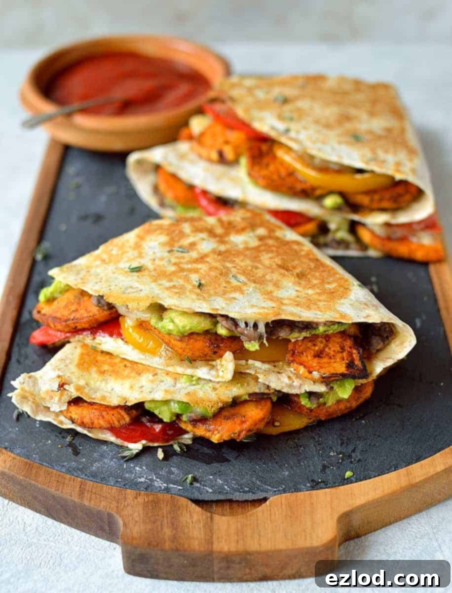 Loaded veggie quesadillas - delicious, filling, healthy quesadillas stuffed with spiced roasted sweet potato, peppers, black beans, avocado, cream cheese and cheddar.