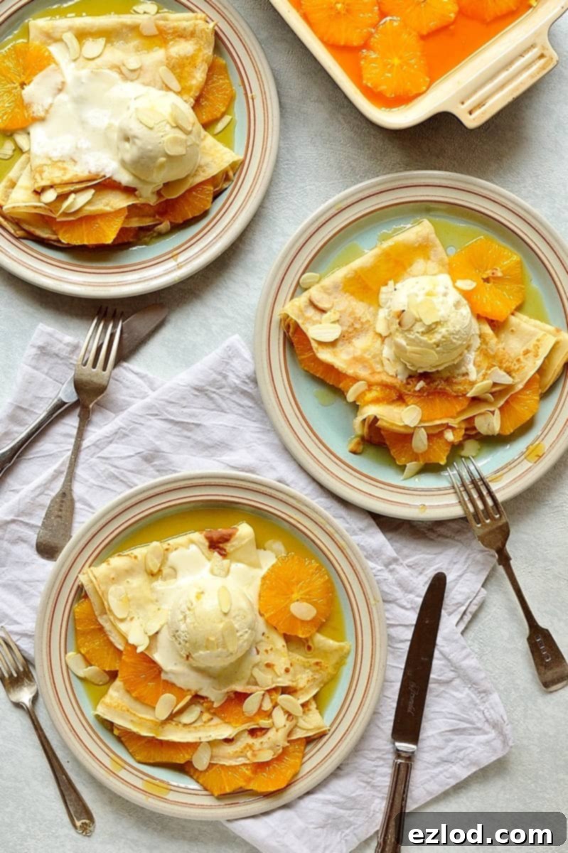 A stunning plate of caramel orange crepes with almond ice cream and toasted almond flakes, ready to be enjoyed.