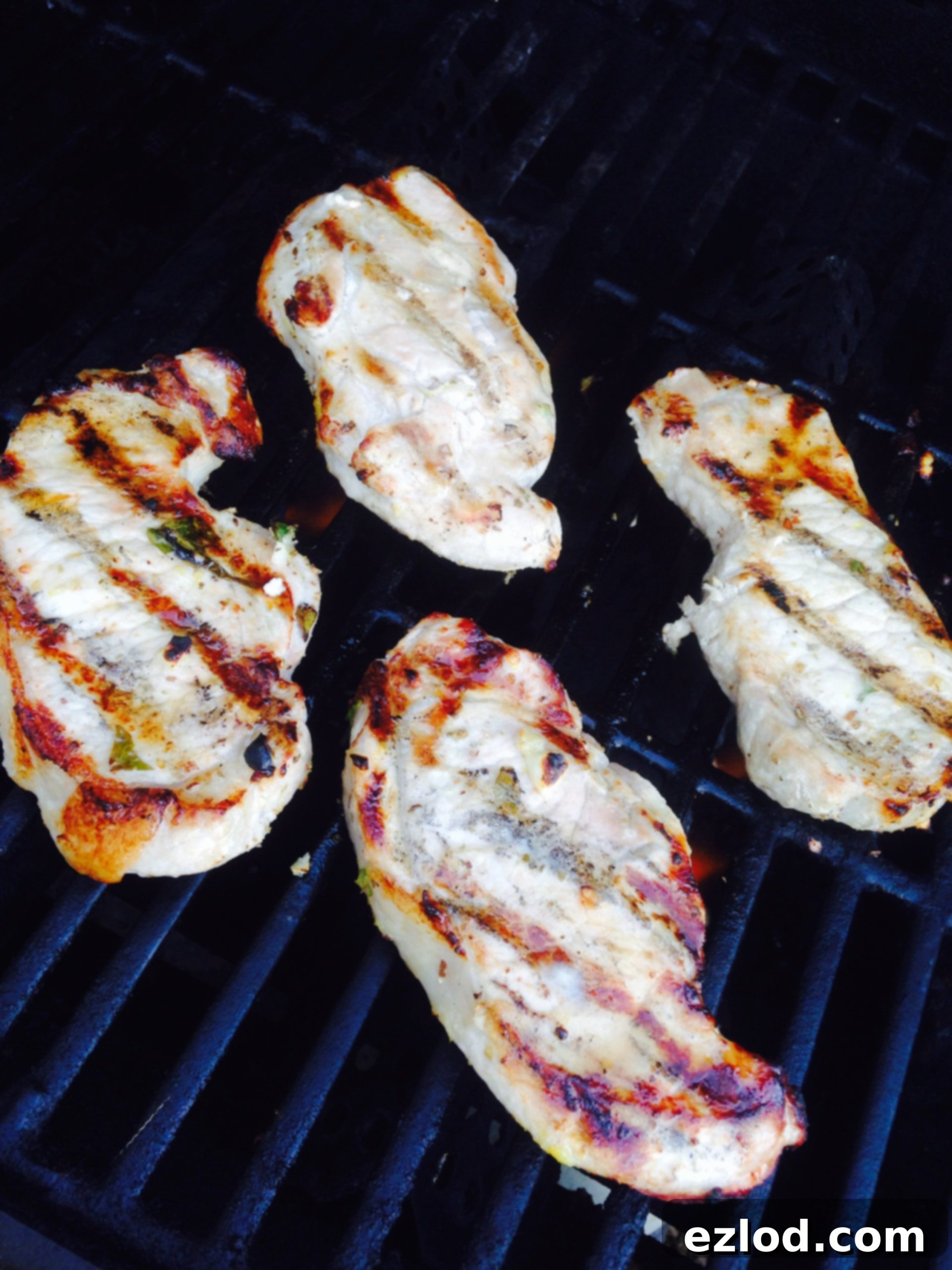 4 porkchops with grill marks lying on the grill