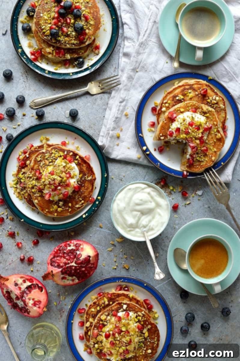 Baklava pancakes - soft, fluffy Greek yoghurt pancakes flavoured with cardamom, cinnamon and chopped pistachios, walnuts and almonds topped with a delicious honey, orange blossom, lemon and rose syrup.
