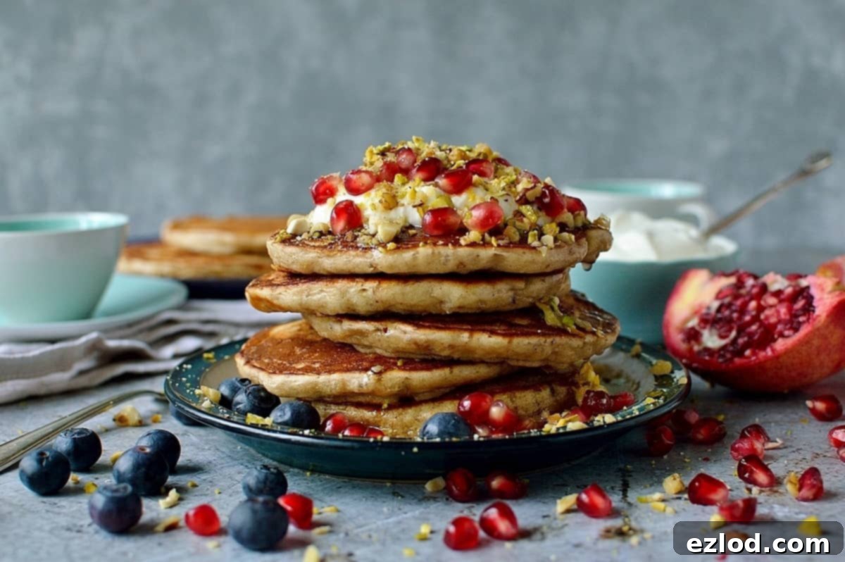 Baklava pancakes - soft, fluffy Greek yoghurt pancakes flavoured with cardamom, cinnamon and chopped pistachios, walnuts and almonds topped with a delicious honey, orange blossom, lemon and rose syrup.