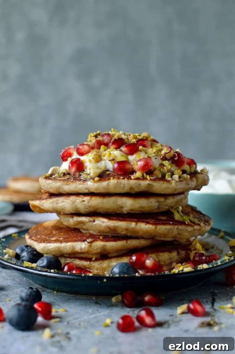 Baklava pancakes - soft, fluffy Greek yoghurt pancakes flavoured with cardamom, cinnamon and chopped pistachios, walnuts and almonds topped with a delicious honey, orange blossom, lemon and rose syrup.