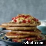 Baklava pancakes - soft, fluffy Greek yoghurt pancakes flavoured with cardamom, cinnamon and chopped pistachios, walnuts and almonds topped with a delicious honey, orange blossom, lemon and rose syrup.