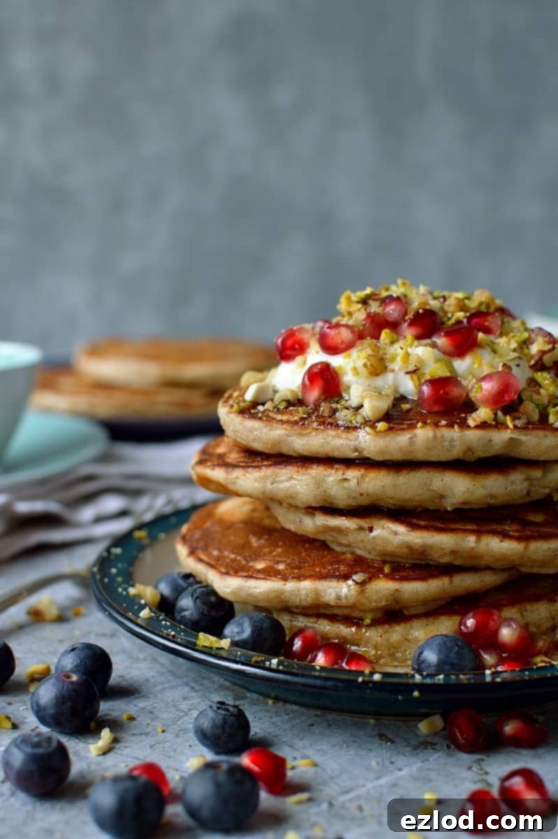 Baklava pancakes - soft, fluffy Greek yoghurt pancakes flavoured with cardamom, cinnamon and chopped pistachios, walnuts and almonds topped with a delicious honey, orange blossom, lemon and rose syrup.