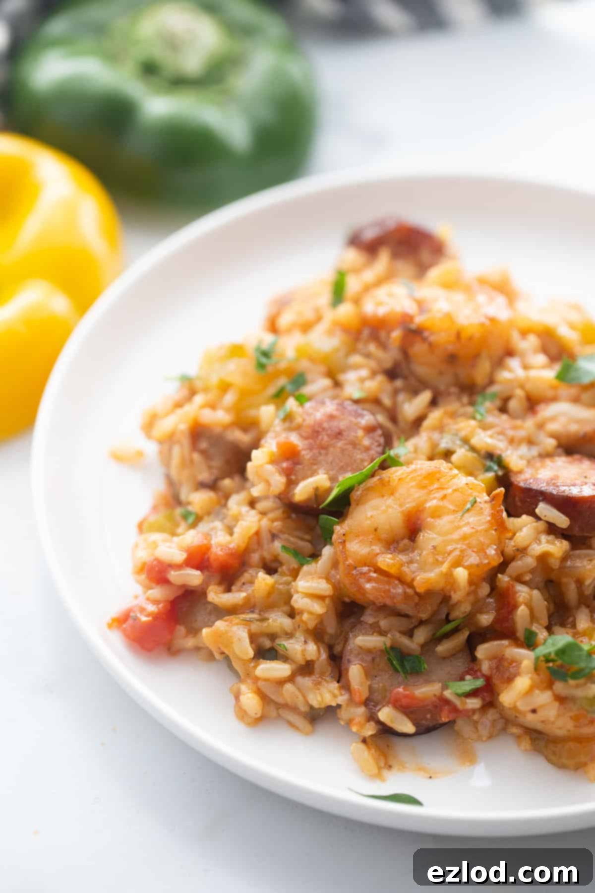 Healthy Jambalaya served on a white plate, resting on a marble counter top.