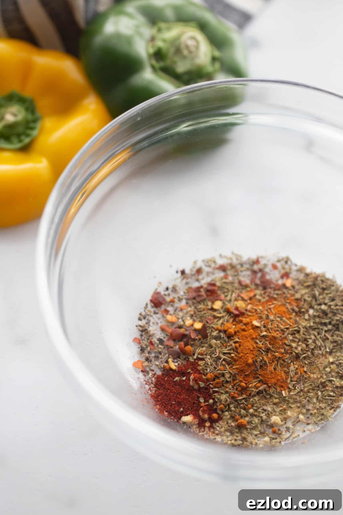 Homemade Cajun seasoning in a small glass bowl, ready for use.