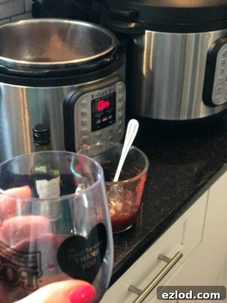 A close-up of the Asian sauce being stirred in the Instant Pot, showing the depth of flavor.