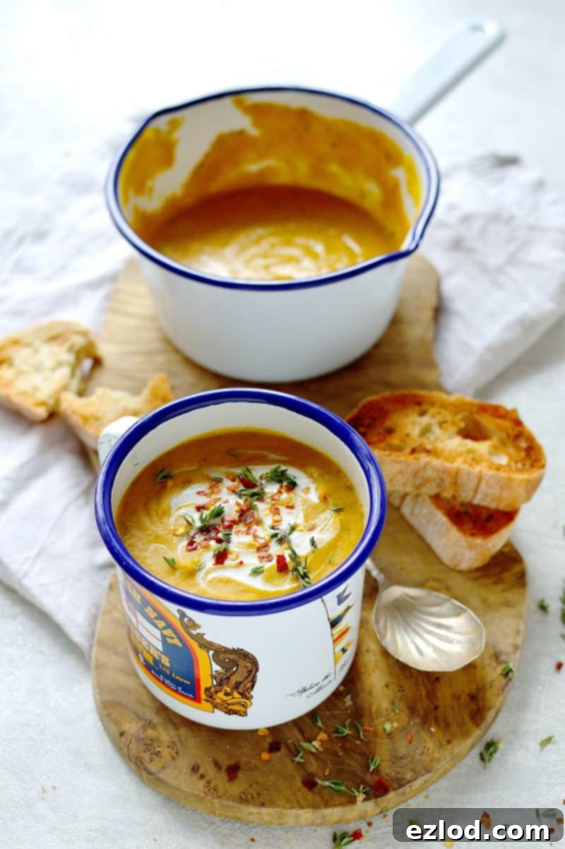 A steaming bowl of hearty vegan spiced red lentil and root vegetable soup, garnished with fresh cilantro, ready to be enjoyed as a healthy and filling meal.