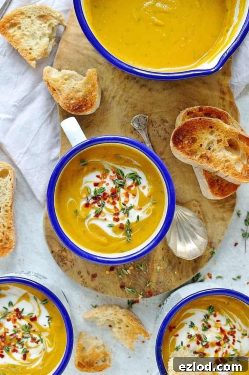 Ingredients for vegan spiced red lentil and root vegetable soup laid out on a wooden cutting board, including fresh vegetables, spices, lentils, and coconut milk.