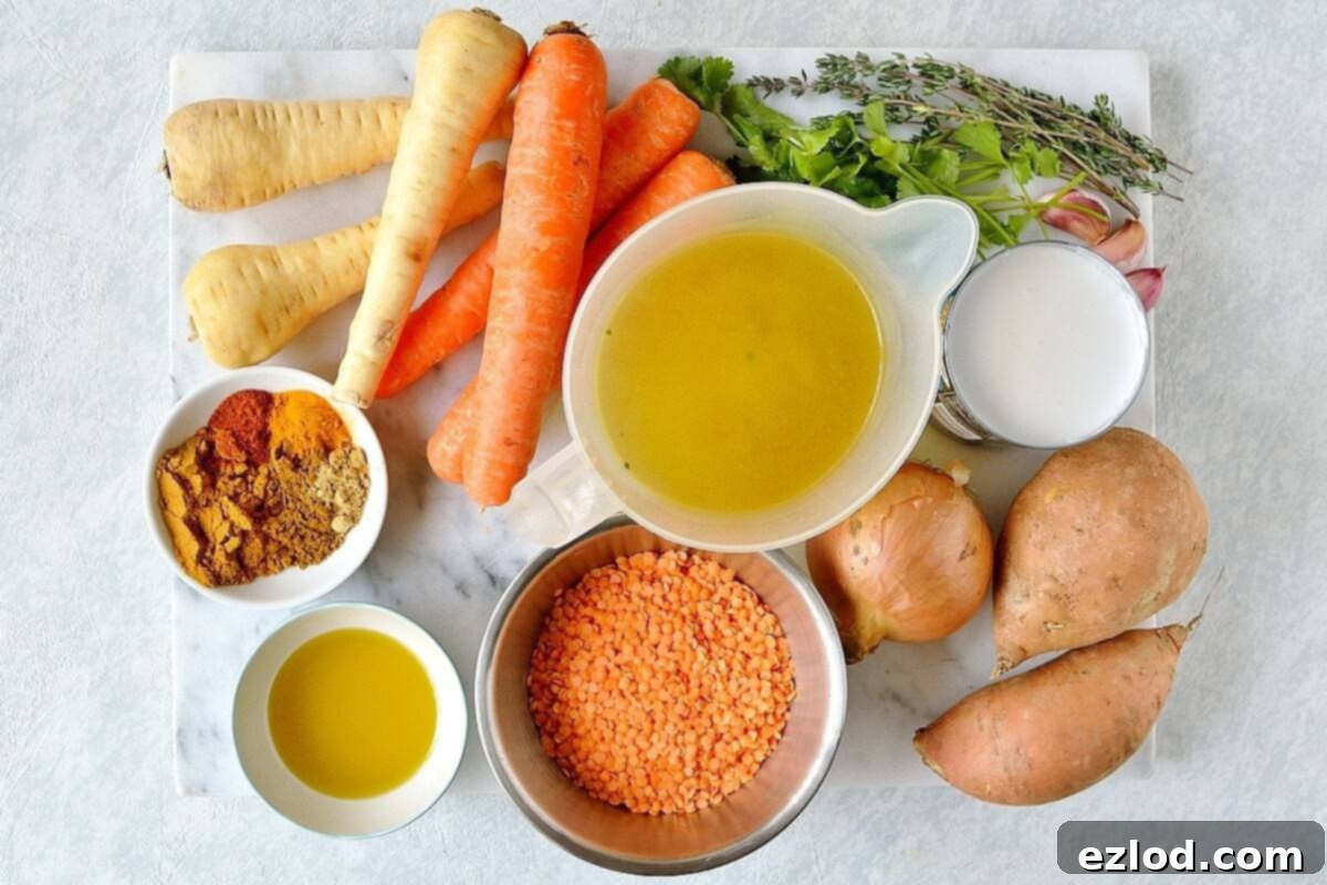 Close-up of chopped onions, carrots, parsnips, and sweet potatoes, along with a selection of dried spices like curry powder and cumin, ready for cooking.