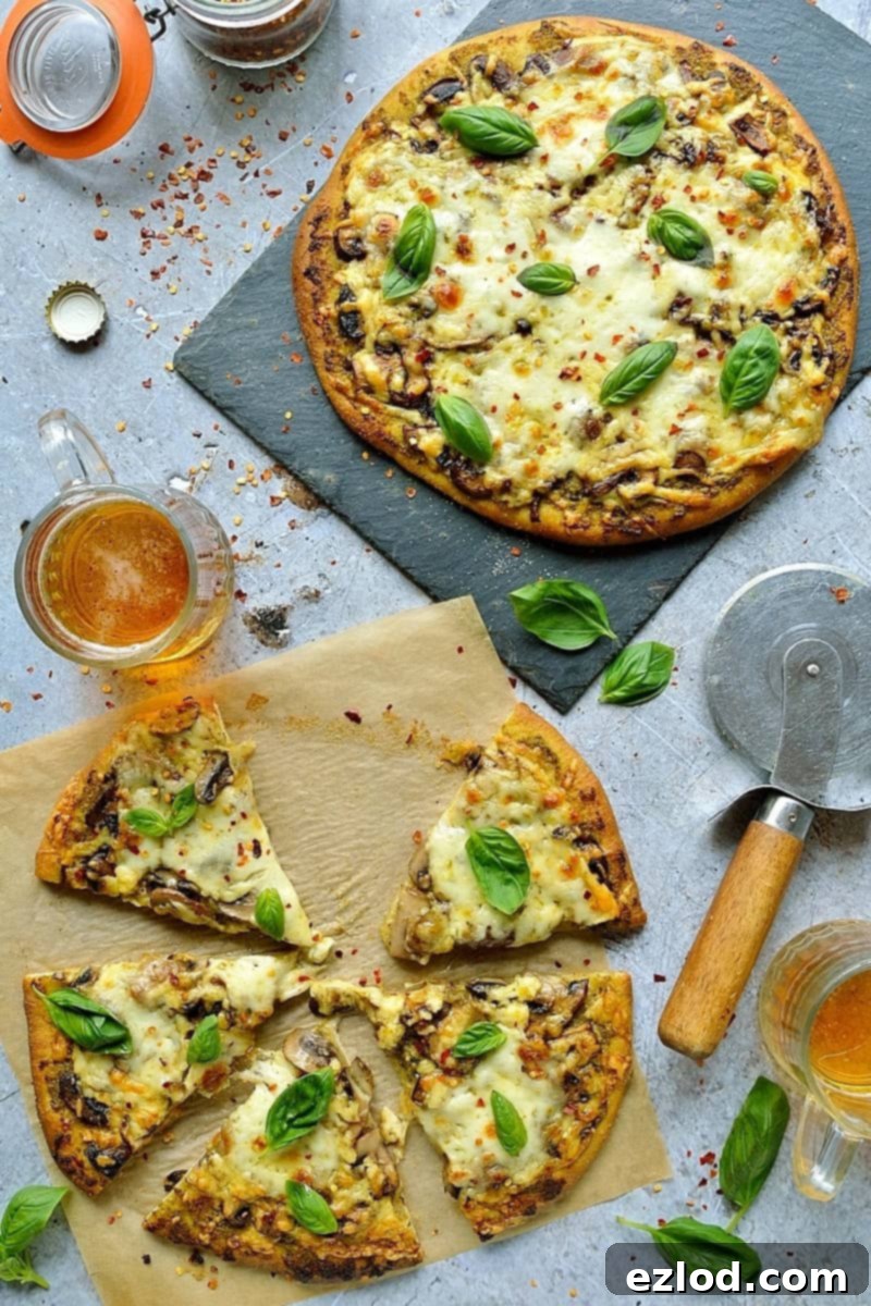 Mushroom pesto pizza - easy home made vegetarian pizza topped with garlic mushrooms, basil pesto and plenty of mozzarella and cheddar cheese.