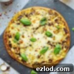 Earthy Pesto Mushroom Pizza 5 Mushroom pesto pizza - easy home made vegetarian pizza topped with garlic mushrooms, basil pesto and plenty of mozzarella and cheddar cheese.