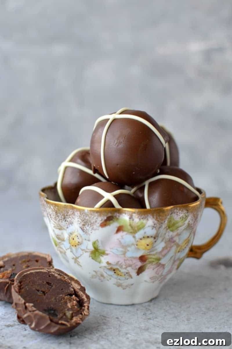 Rich, spiced dark chocolate ganache truffles, inspired by hot cross buns, topped with a delicate white chocolate cross – an exquisite Easter confectionery.