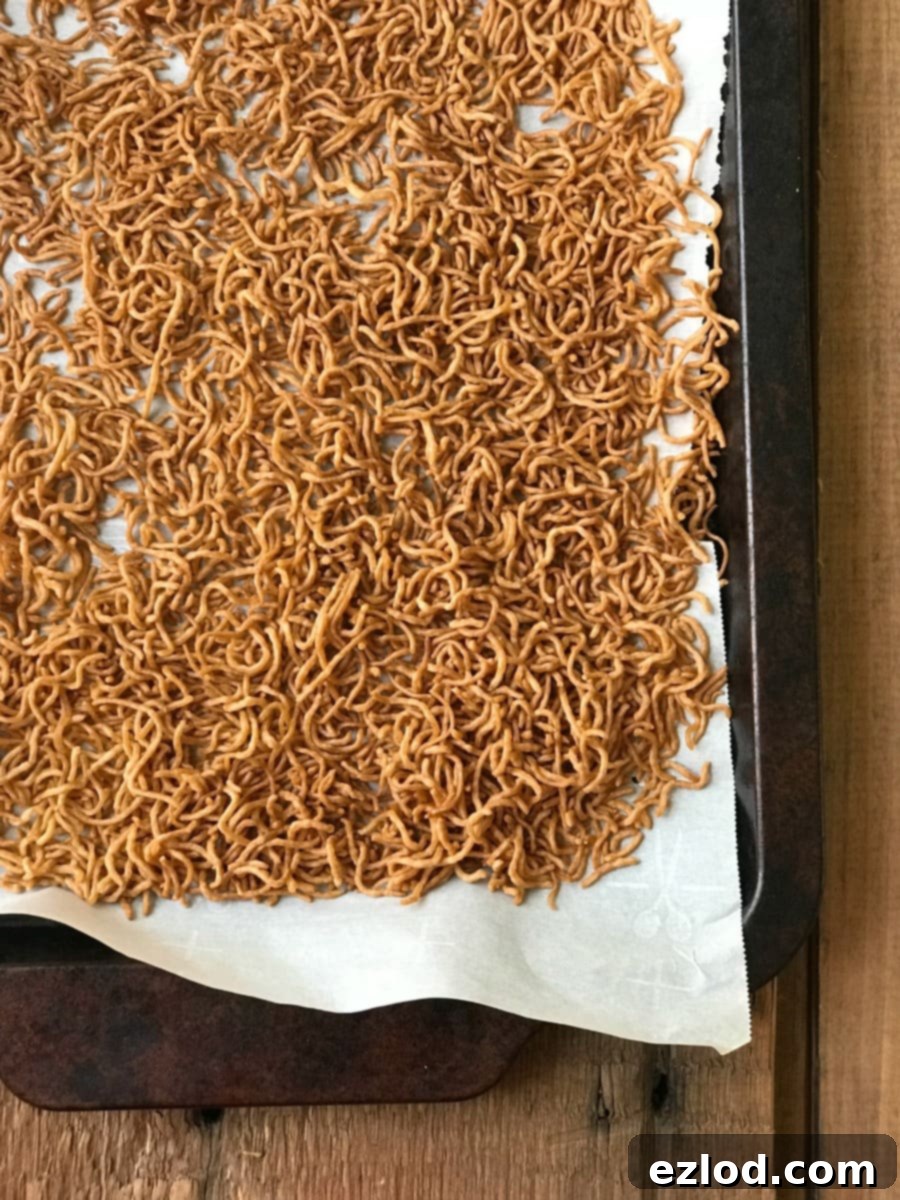 Toasted Ramen Noodles on a parchment paper lined Sheet Pan
