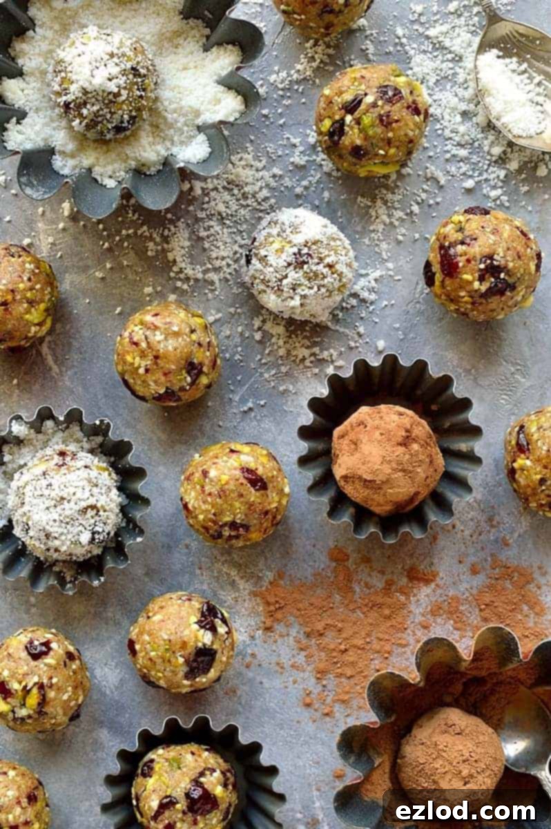 Close-up of freshly made cranberry, pistachio, and coconut energy bites, perfectly round and vibrant – ideal for a healthy vegan snack.