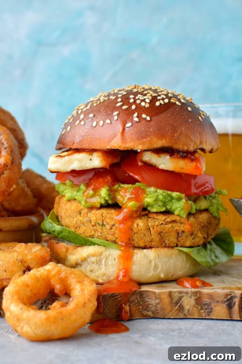 Delicious Sun-Dried Tomato Chickpea Burgers and crispy Beer-Battered Onion Rings - a perfect vegetarian/vegan meal.