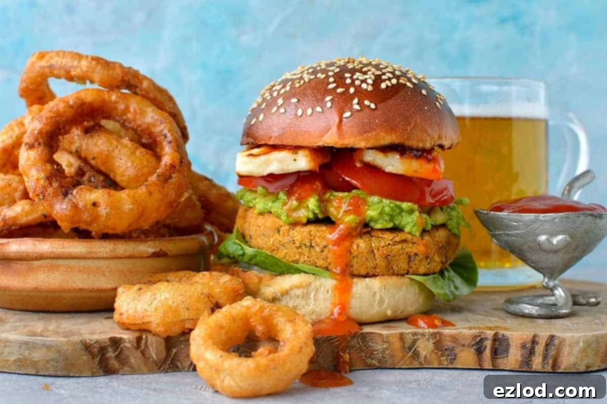 Homemade Sun-Dried Tomato Chickpea Burgers and Beer-Battered Onion Rings – a gourmet plant-based meal.