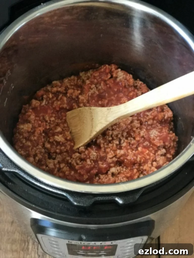 Dividing cooked taco meat into freezer bags