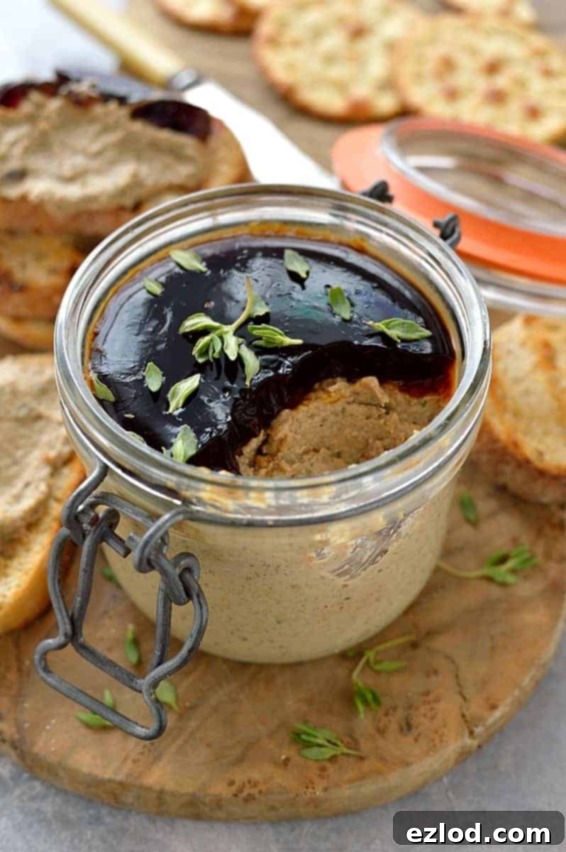 Vegetarian mushroom pâté presented in a rustic jar, garnished with fresh herbs, ready to be served.