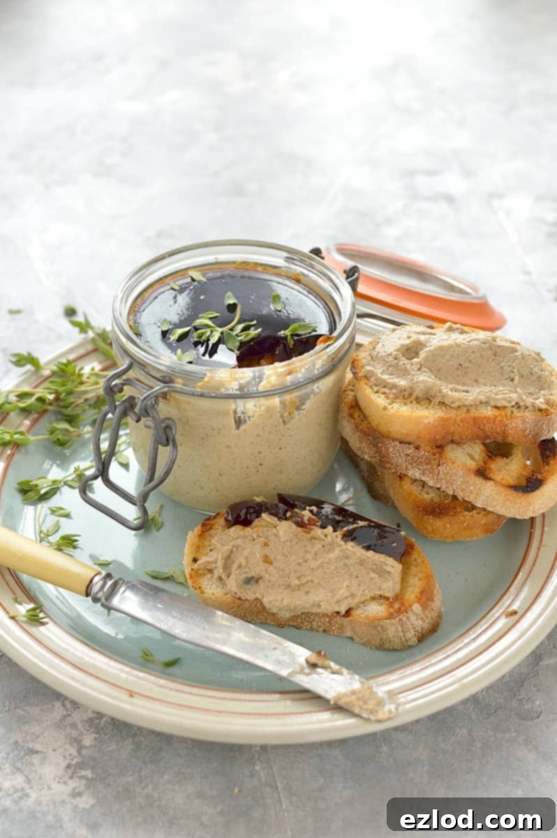 Close-up of mushroom pâté with a glistening jelly topping, ready to be scooped or spread.