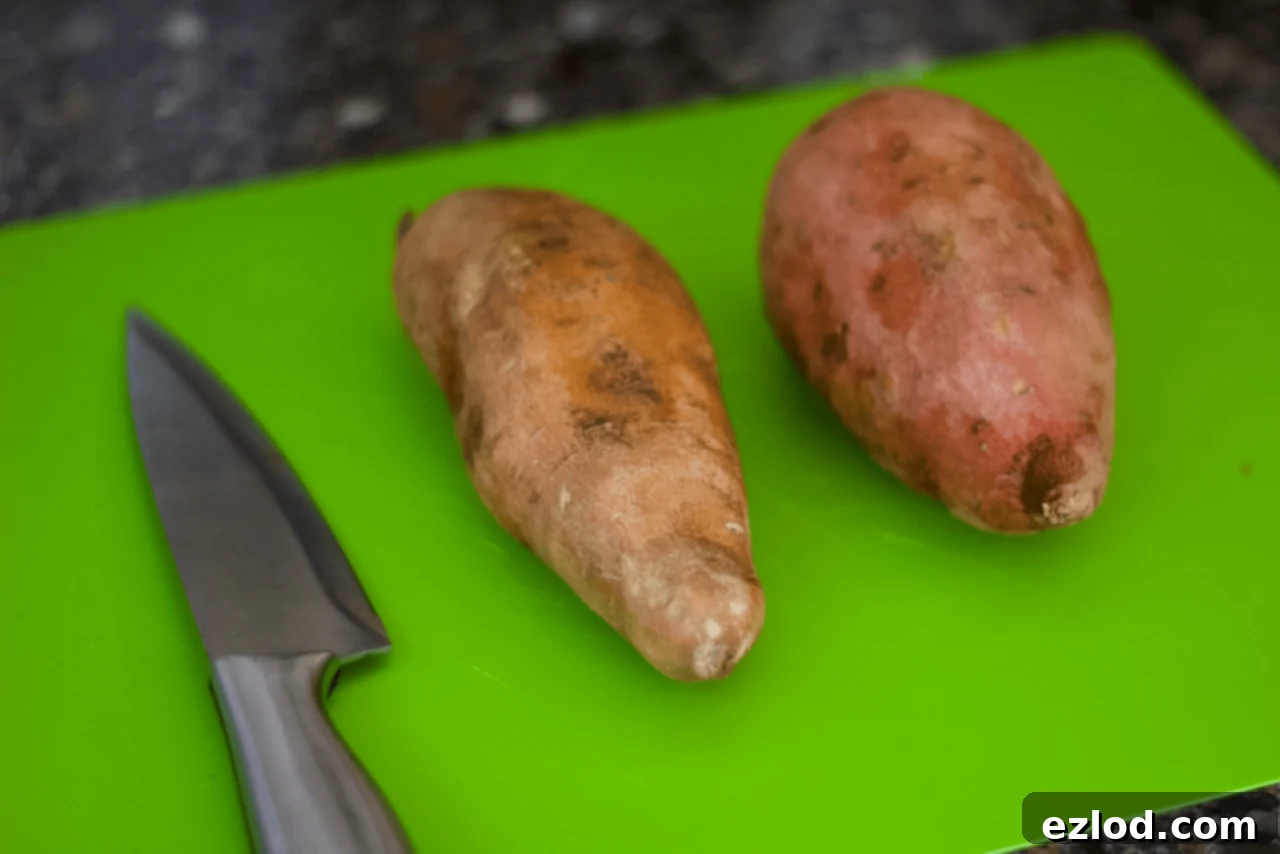 How to Meal Prep Sweet Potato Toast: An overhead shot of sliced sweet potatoes arranged on a baking sheet, ready for the oven, highlighting the ease of large-batch cooking for meal prep.