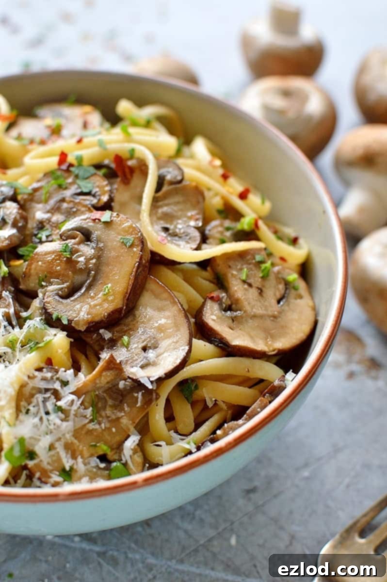 Sautéed mushrooms and garlic in a frying pan, ready for linguine