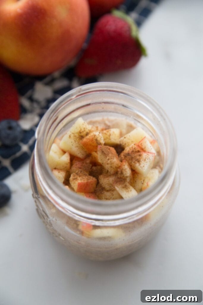 A jar of apple cinnamon overnight oats topped with extra cinnamon