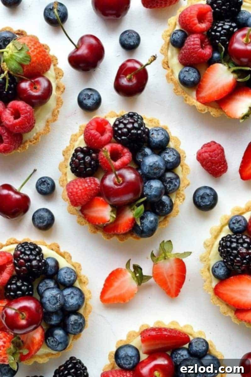Coconut and berry fruit tarts - crisp coconut pastry with coconut pastry cream and fresh berries.