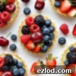 Coconut and berry fruit tarts - crisp coconut pastry with coconut pastry cream and fresh berries.