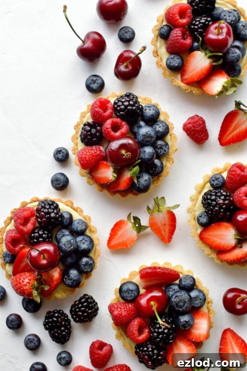 Coconut and berry fruit tarts - crisp coconut pastry with coconut pastry cream and fresh berries.