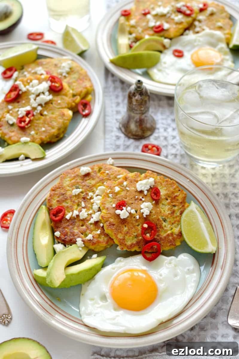 Close-up view of Sweetcorn and Feta Fritters cooking in a pan, golden and sizzling, highlighting the frying process and inviting aroma.