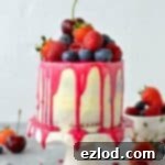 White Chocolate Berry Cascade Mini Cake 6 Mini white chocolate berry drip cake - delicious, moist vanilla cake with whipped white chocolate gananche, pink white chocolate drip and fresh berries; serves just 2-4 people!