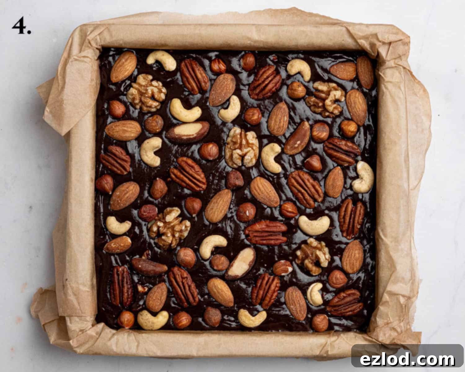 Boozy Vegan Nut Brownie Bliss 8 Step 4: The assembled brownies in the pan, topped with whole nuts, ready to go into the oven.