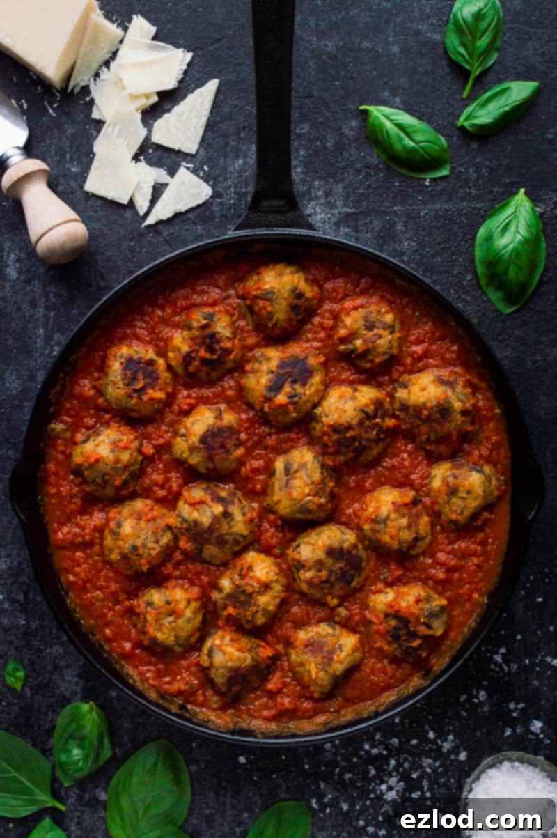 Vegetarian mushroom meatballs with tomato ragu sauce in a black skillet